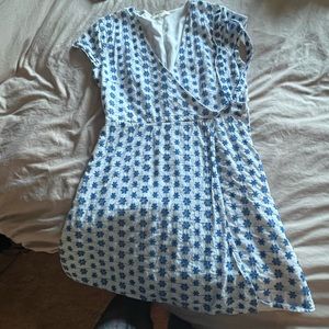 Size small dress has strings on the front to tie and zips on the side